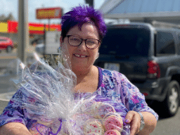 Image of Pastor Jeanie holding gifts for the women working in the strip clubs.